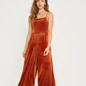 Velvet jumpsuit with adjustable straps. Burnt Orange/rust colored